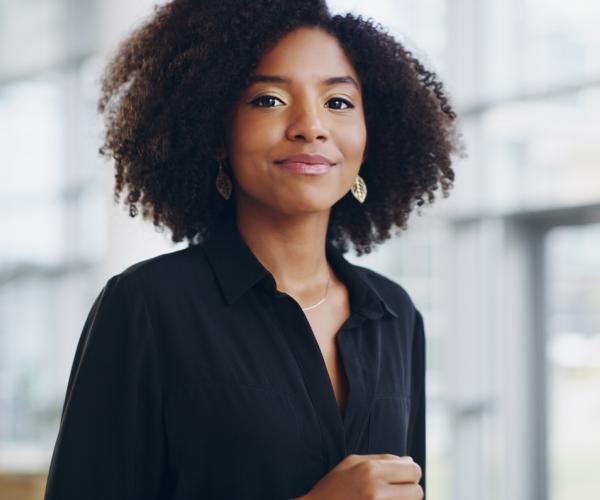 Businesswoman smiling in building lobby.