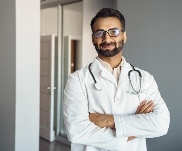 Doctor smiling with crossed arms. 