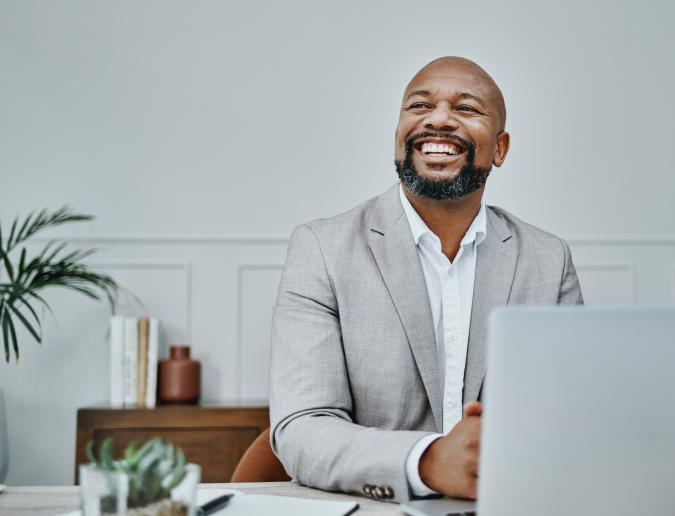 Businessman sitting at table with laptop